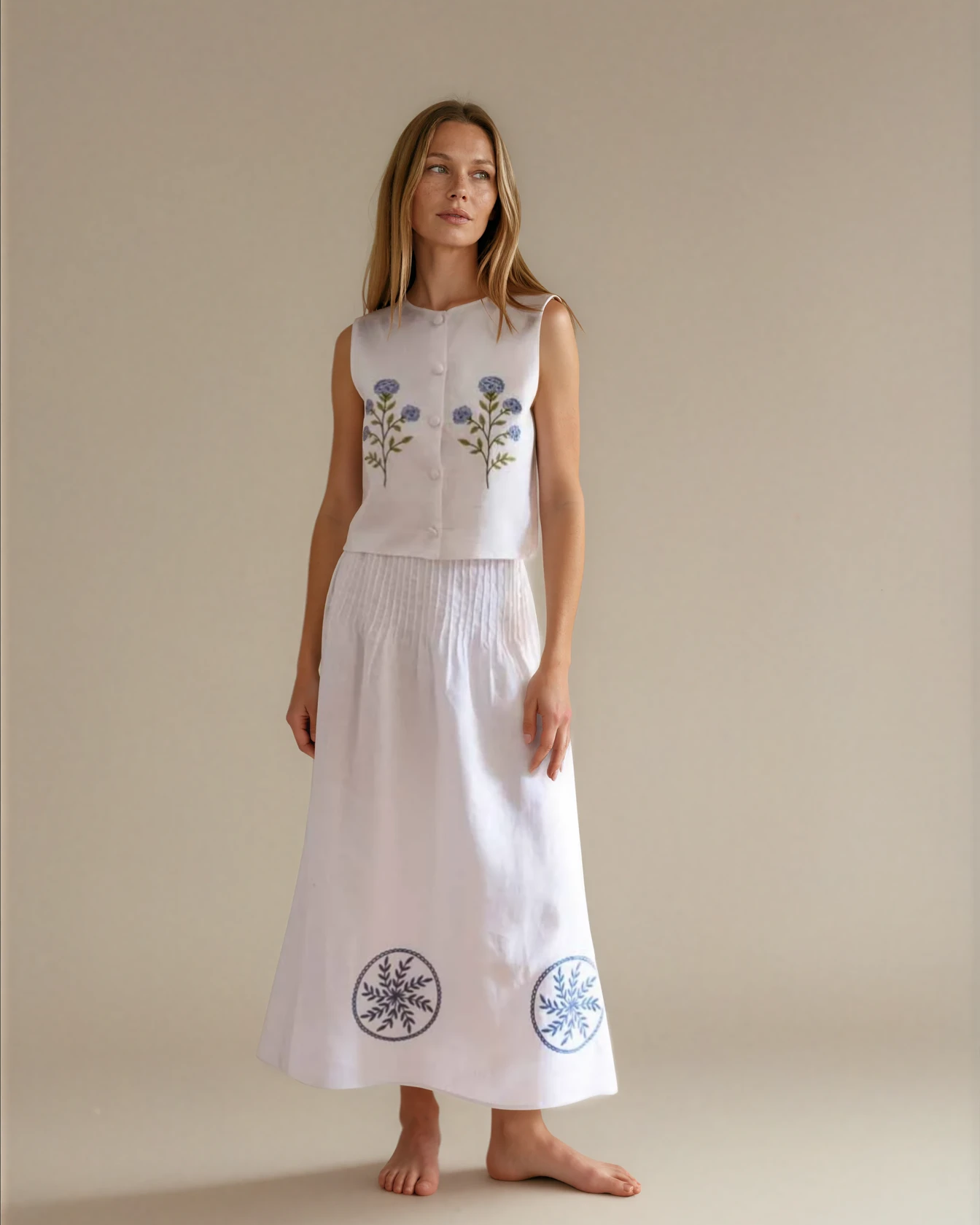 woman wearing a white linen set with flower embroidery