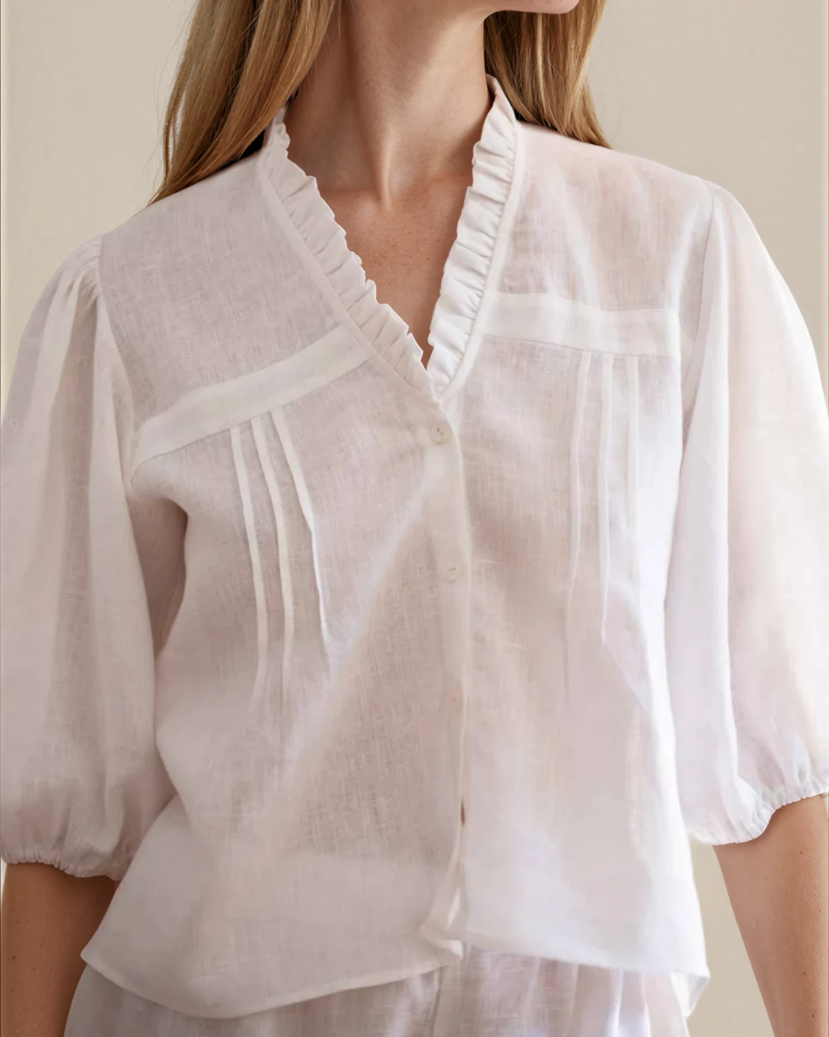white linen blouse with V neck and embroidered sleeves 